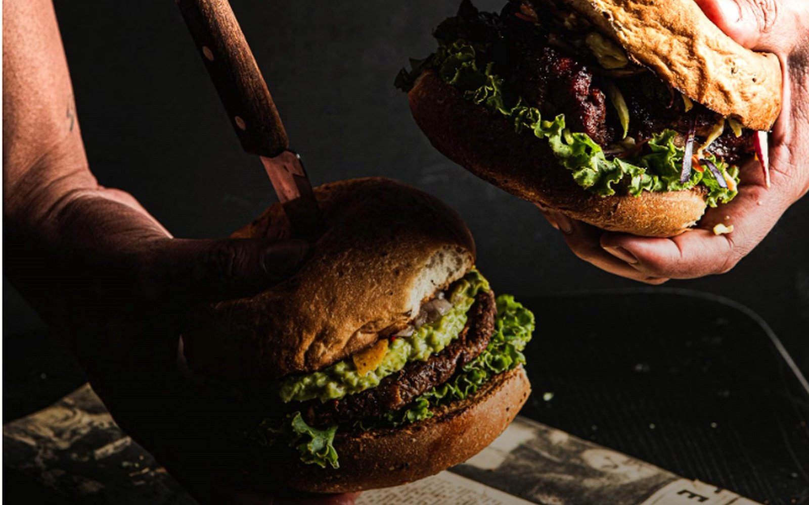 Two freshly prepared burgers on the pass